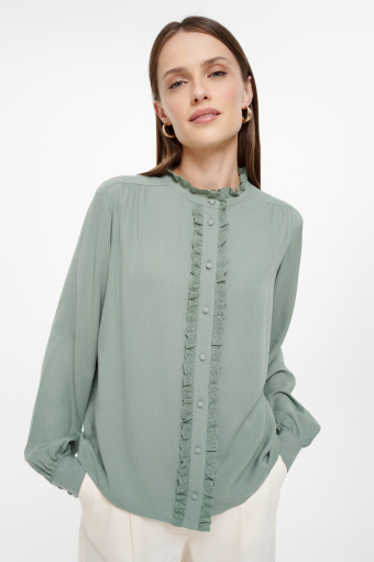 Pastelowo-zielona bluzka z riuszką