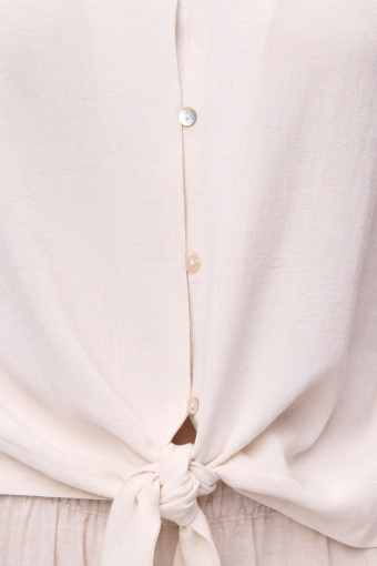 Jasnobeżowa klasyczna bluzka z wiązaniem u dołu Jasnobeżowa klasyczna bluzka z wiązaniem u dołu