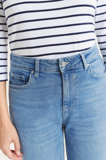 Niebieskie jeansy z podwiniętymi nogawkami