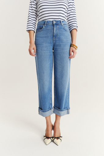 Niebieskie jeansy z podwiniętymi nogawkami