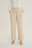 Luźne kremowe spodnie z gumką w talii